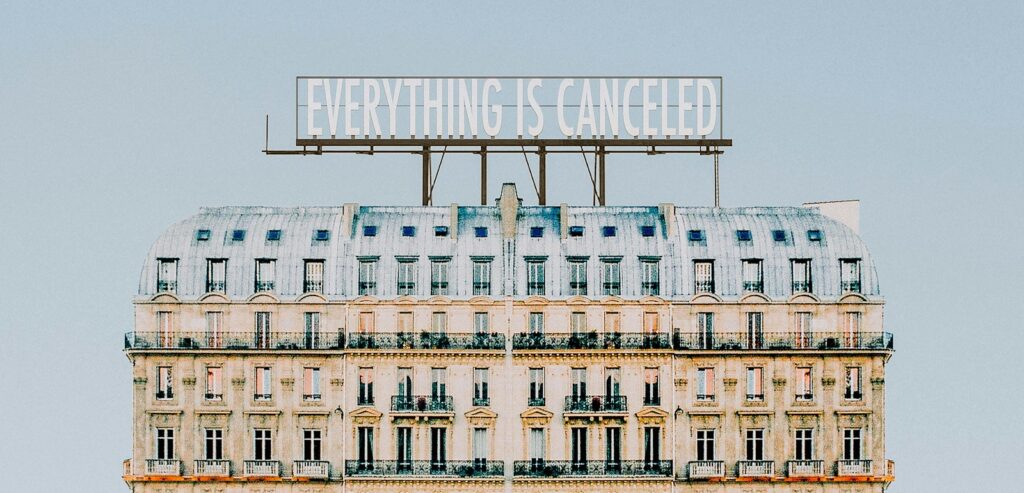 Building with sign on top that says 'everything is cancelled.'